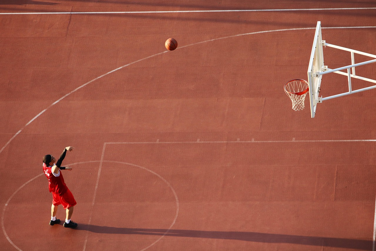 person shooting a basketball